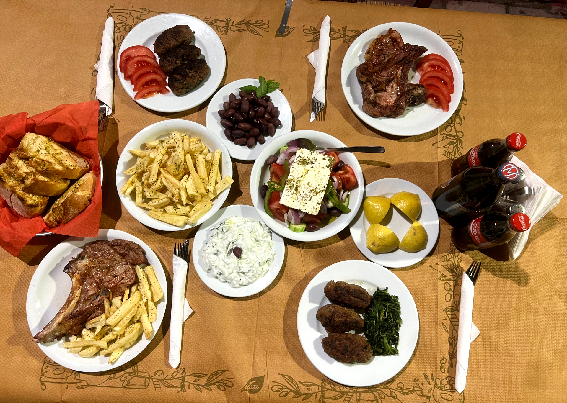 Family grilling lamb chops over charcoal at To Steki Tou Hlia, Athens